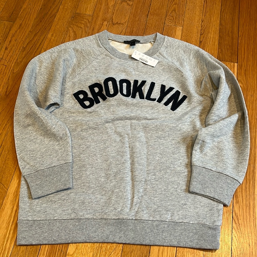 Tags on J Crew medium gray sweatshirt with dark blue lettering. brand new